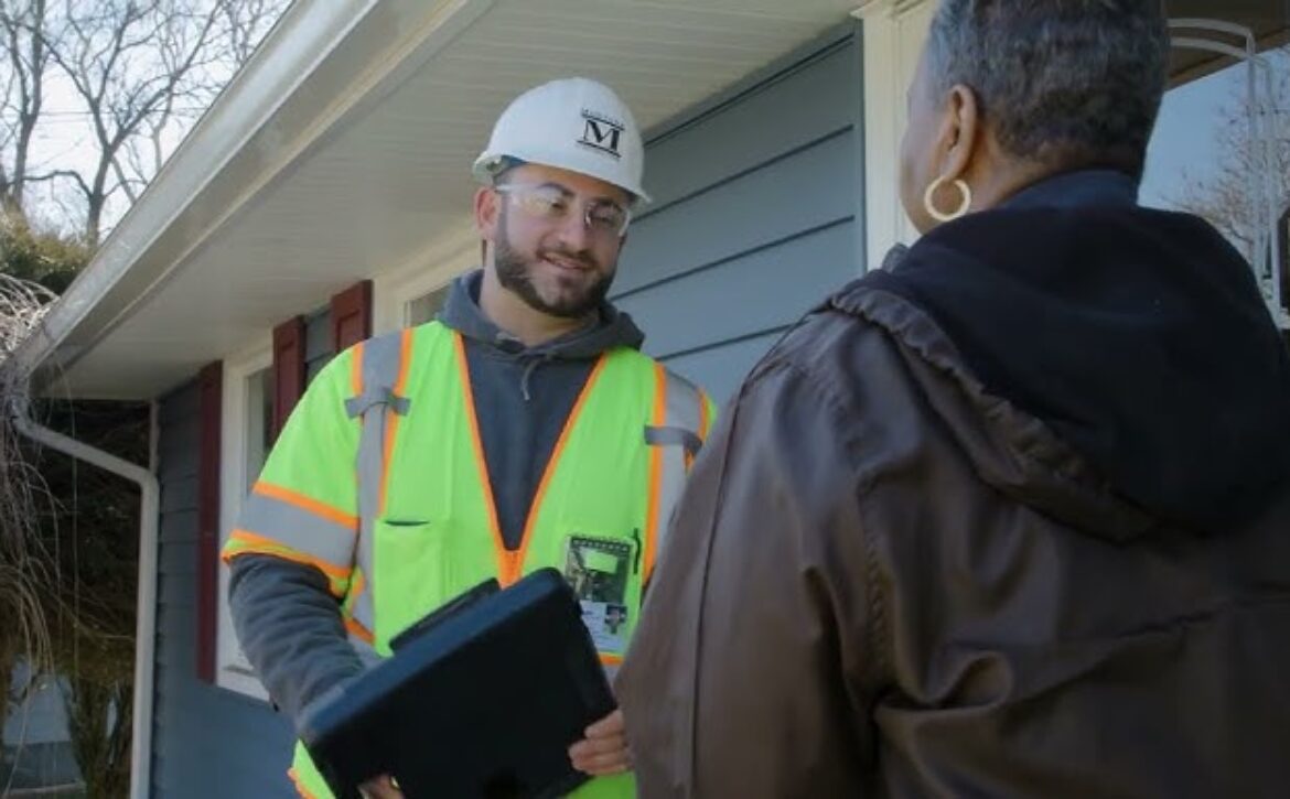 Construction worker speaks with a homeowner