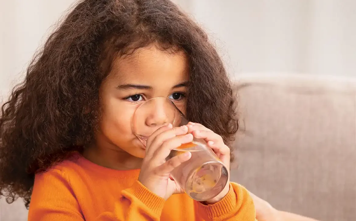 Young girl drinking water