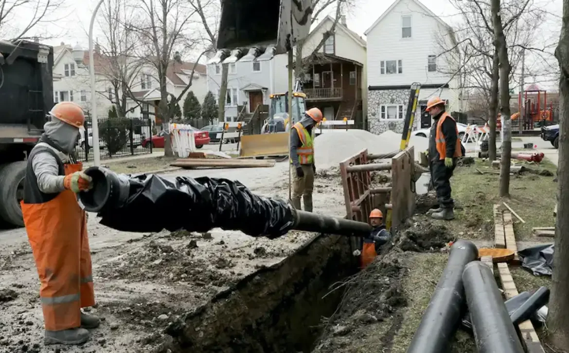 Chicago Department of Water Management crews install water main pipe.
