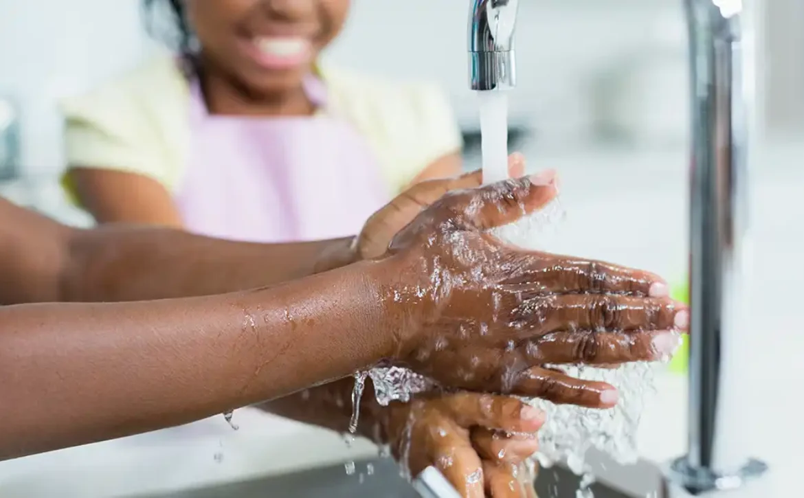 Washing hand in kitchen at home